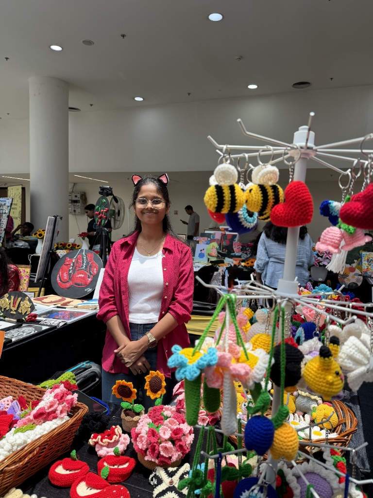 Artisan with handmade crochet creations at stall in Hyderabad